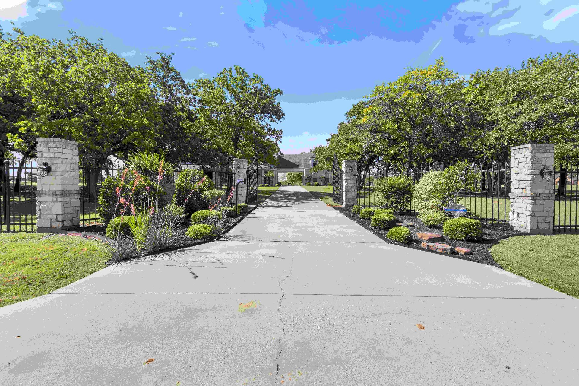 Gated stone-column driveway entry to 259 King Ranch Court
