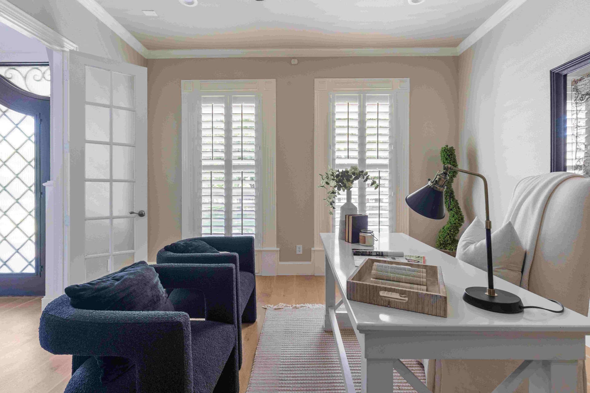 Study with French doors, tall shuttered windows, and writing desk