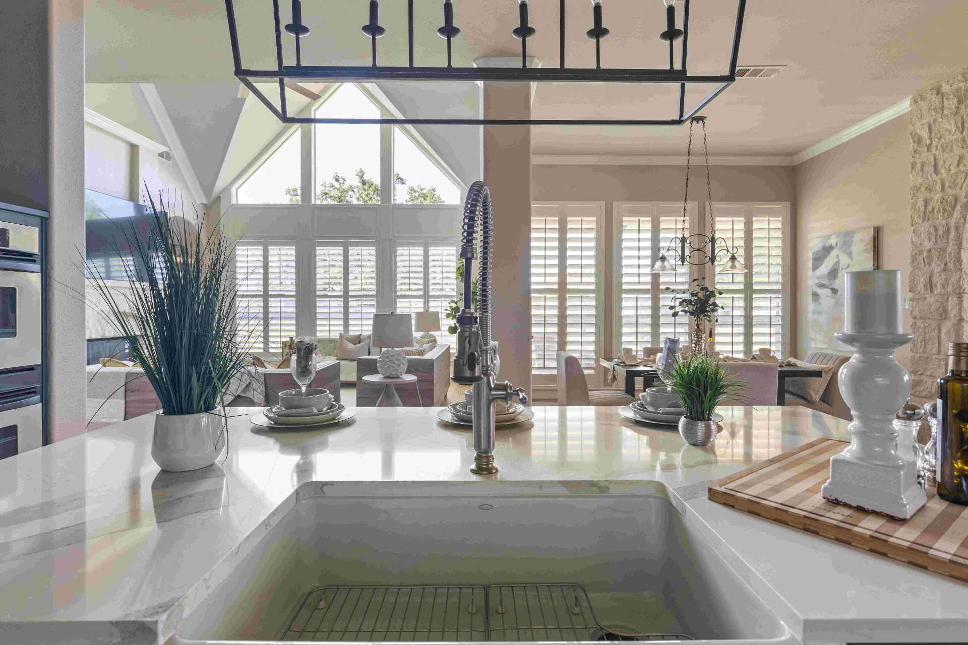 Kitchen island farmhouse sink with view through to vaulted living room