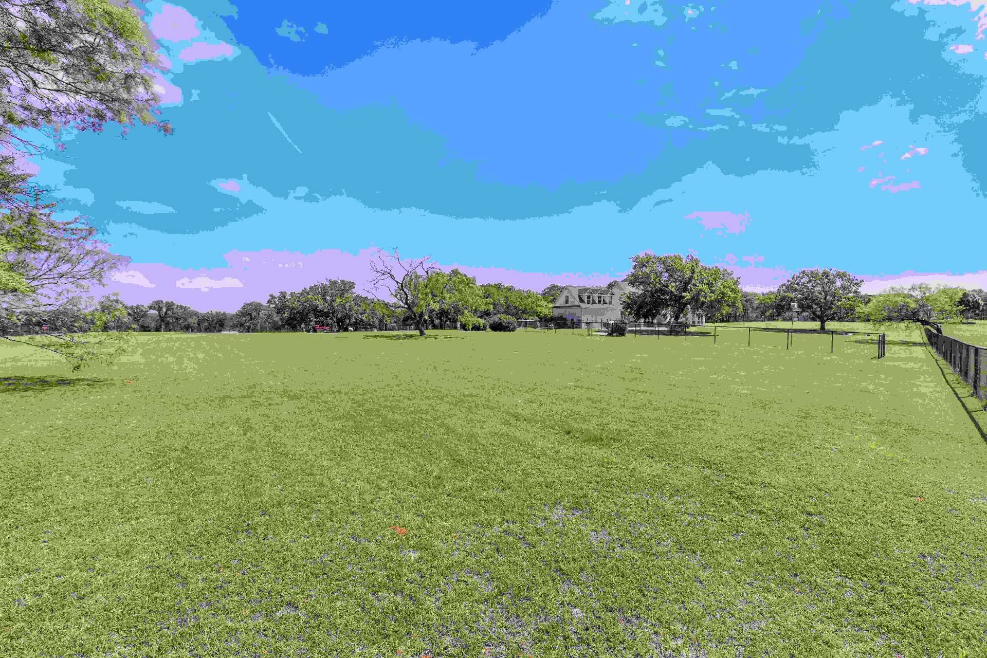 Open pasture and pipe fencing on the 3.63-acre lot