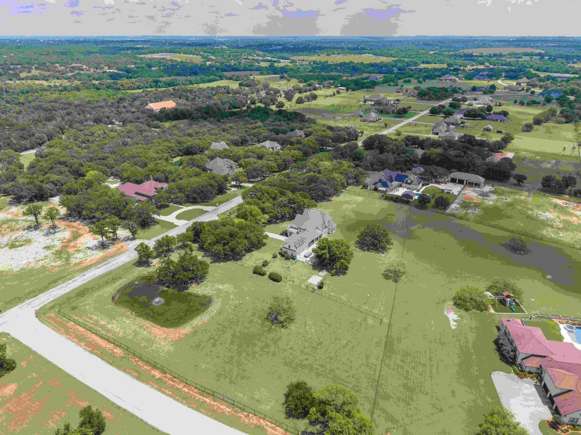Aerial showing the property boundaries, tank, and pasture